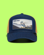 BORN FREE EAGLE BLUE TRUCKER HAT WITH MOUNTAIN LANDSCAPE