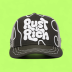 DARK GREEN TRUCKER CAP WITH BOLD WHITE RUST AND RICH LOGO
