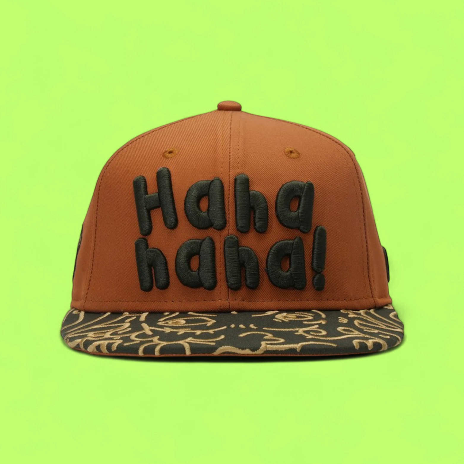 BROWN SNAPBACK CAP WITH GREEN LETTERS AND PATTERNED VISOR